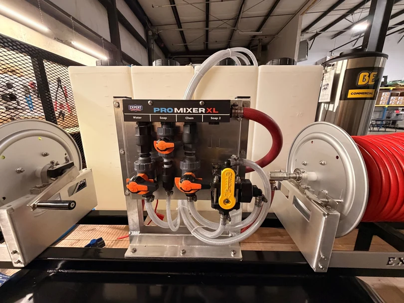 Metered mixing station on the trailer with water, soap, and chemical valves between two hose reels