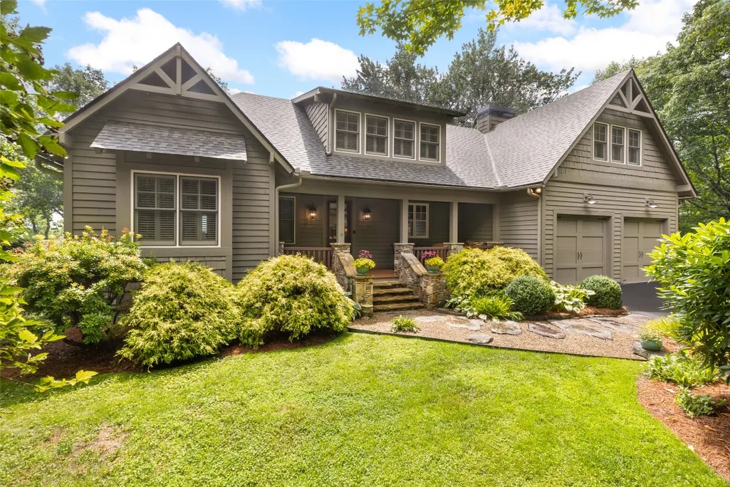 Large craftsman home with dormers and manicured landscaping