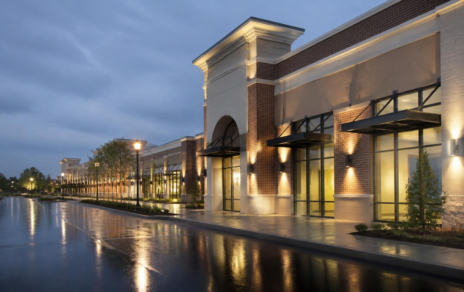 Retail center storefronts at dusk